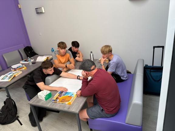 Group people in lifeguard course workout around table