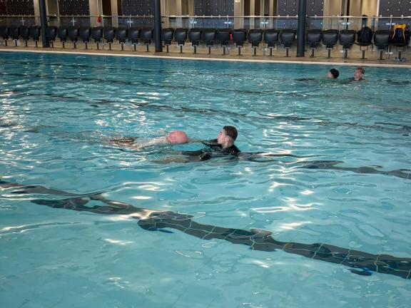 Swimming someone to safety in pool