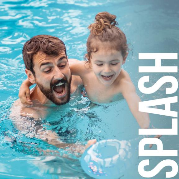 Parent and young child in swimming pool playing with wording 'SPLASH'