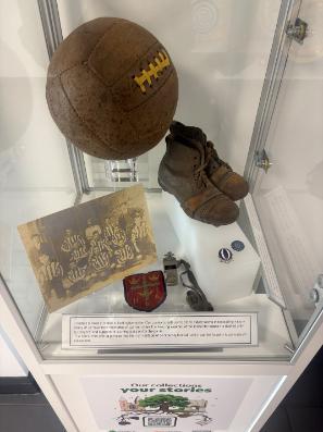 Museum Box with a football, football boots, picture of football team and badges