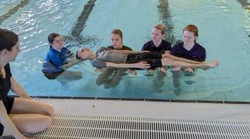 Image of students in a pool on a lifeguard course